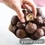 How to Make Homemade Martha Washington Candies: Old-Fashioned Recipe 6 hand lifting a piece of candy out of a bowl of more candies