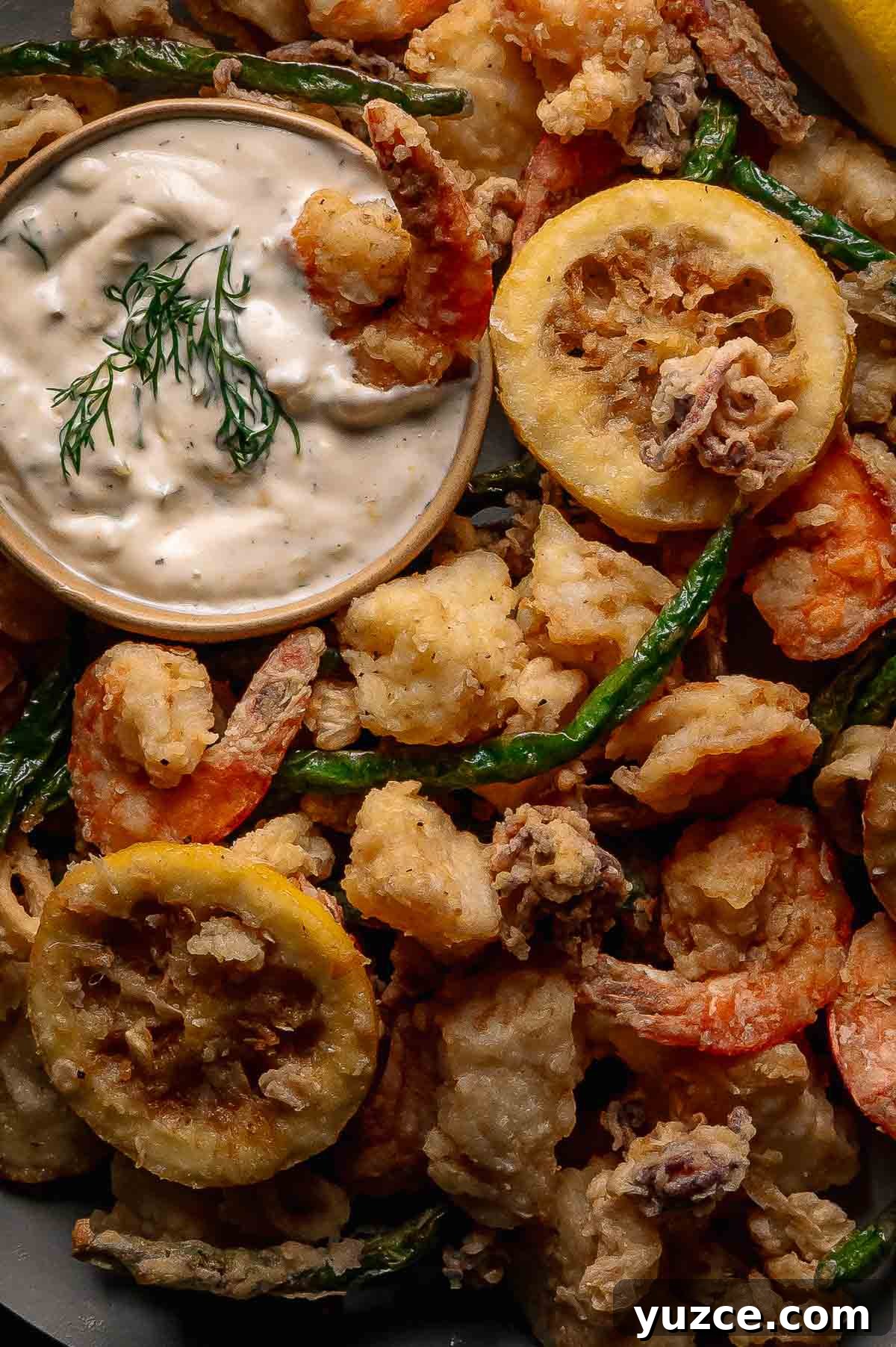 Crispy Fritto Misto with Lemon-Dill Tartar Sauce 4 Fritto misto: a close up of plate of assorted fried seafood and vegetables with a small bowl of creamy tartar sauce garnished with fresh dill.