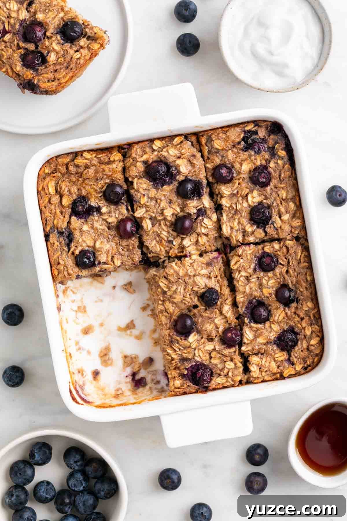 Vegan Baked Oatmeal Recipe with Fruit and Nuts 2 Vegan baked oatmeal cut into squares in a baking dish.