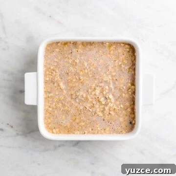 Vegan Baked Oatmeal Recipe with Fruit and Nuts 15 Vegan baked oatmeal mixture transferred to a baking dish.