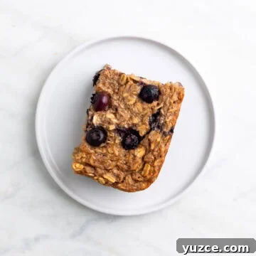 Vegan Baked Oatmeal Recipe with Fruit and Nuts 18 Slice of vegan baked oatmeal served on a plate.