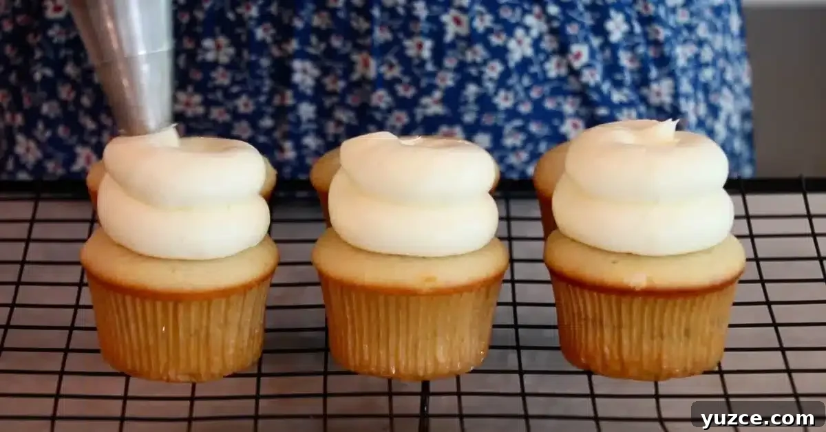 Luscious Lemon Buttercream Frosting Recipe for Cakes and Cupcakes 4 lemon cupcakes with lemon buttercream on top