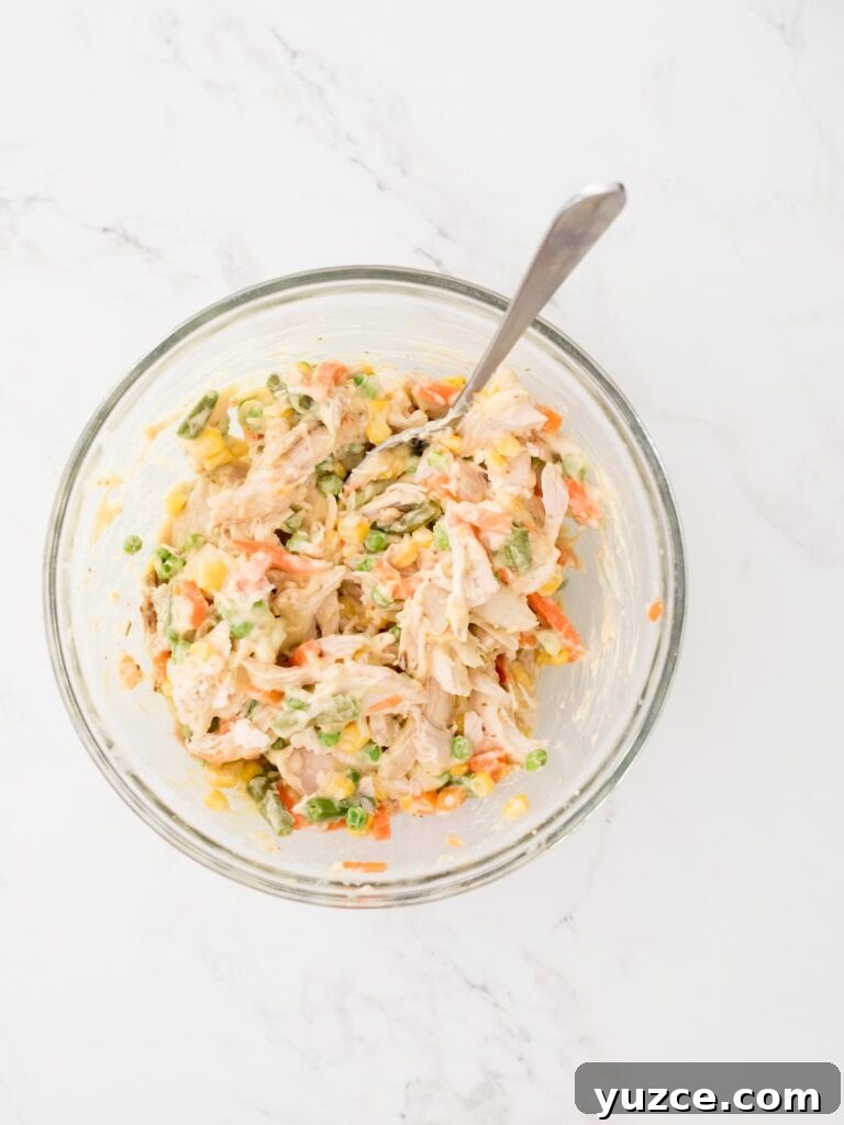 Mini Chicken Pot Pies Baked in Crescent Rolls 5 filling mixed up in a mixing bowl