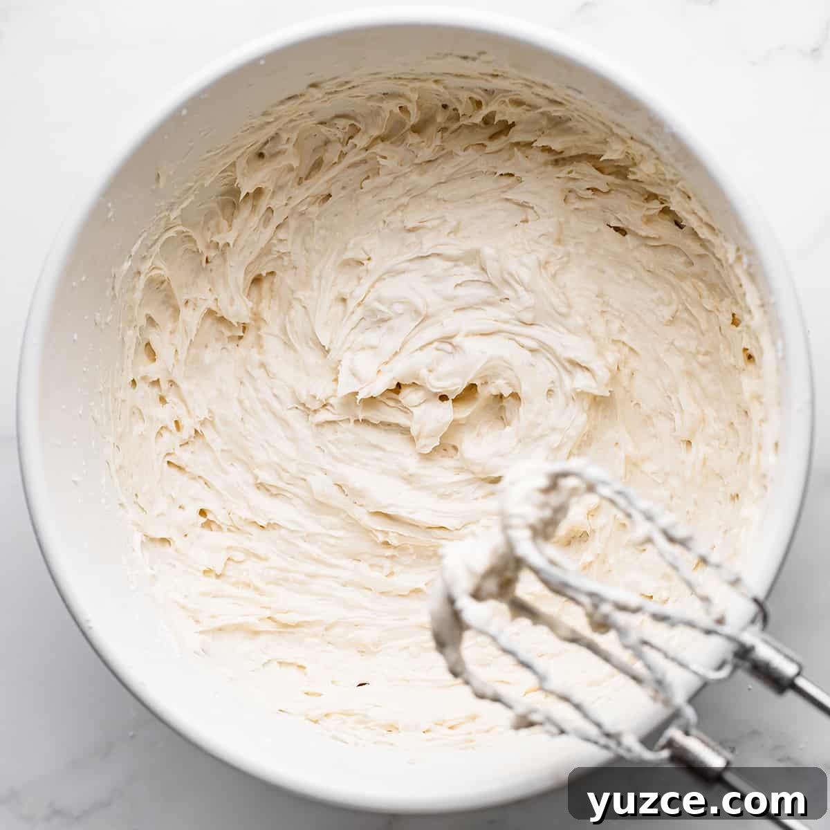Moist Coconut Layer Cake Recipe 14 how to make coconut cake- a bowl of coconut frosting
