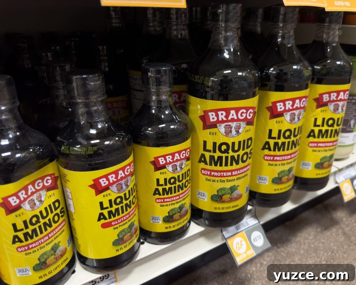 Top Substitutes for Coconut Aminos: Soy & Allergen-Free Options 5 Bottles of liquid aminos on the shelf at the grocery store.