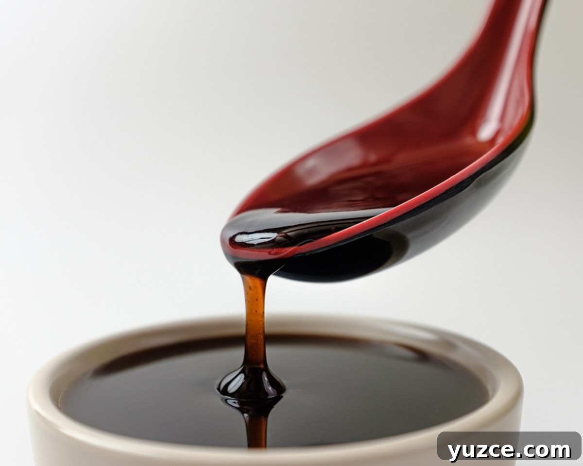 Top Substitutes for Coconut Aminos: Soy & Allergen-Free Options 6 Spoon pouring teriyaki sauce into a bowl.