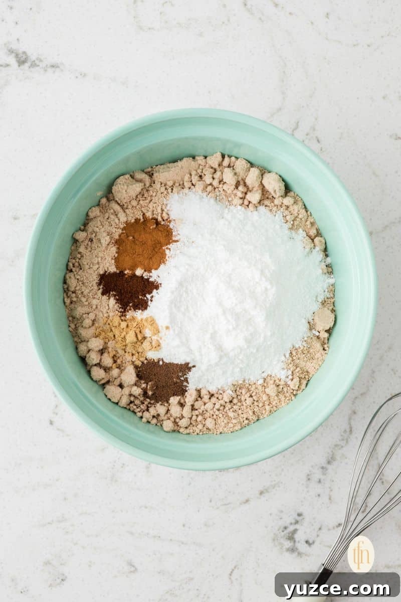 Mixed ingredients of cake recipe in a green bowl.