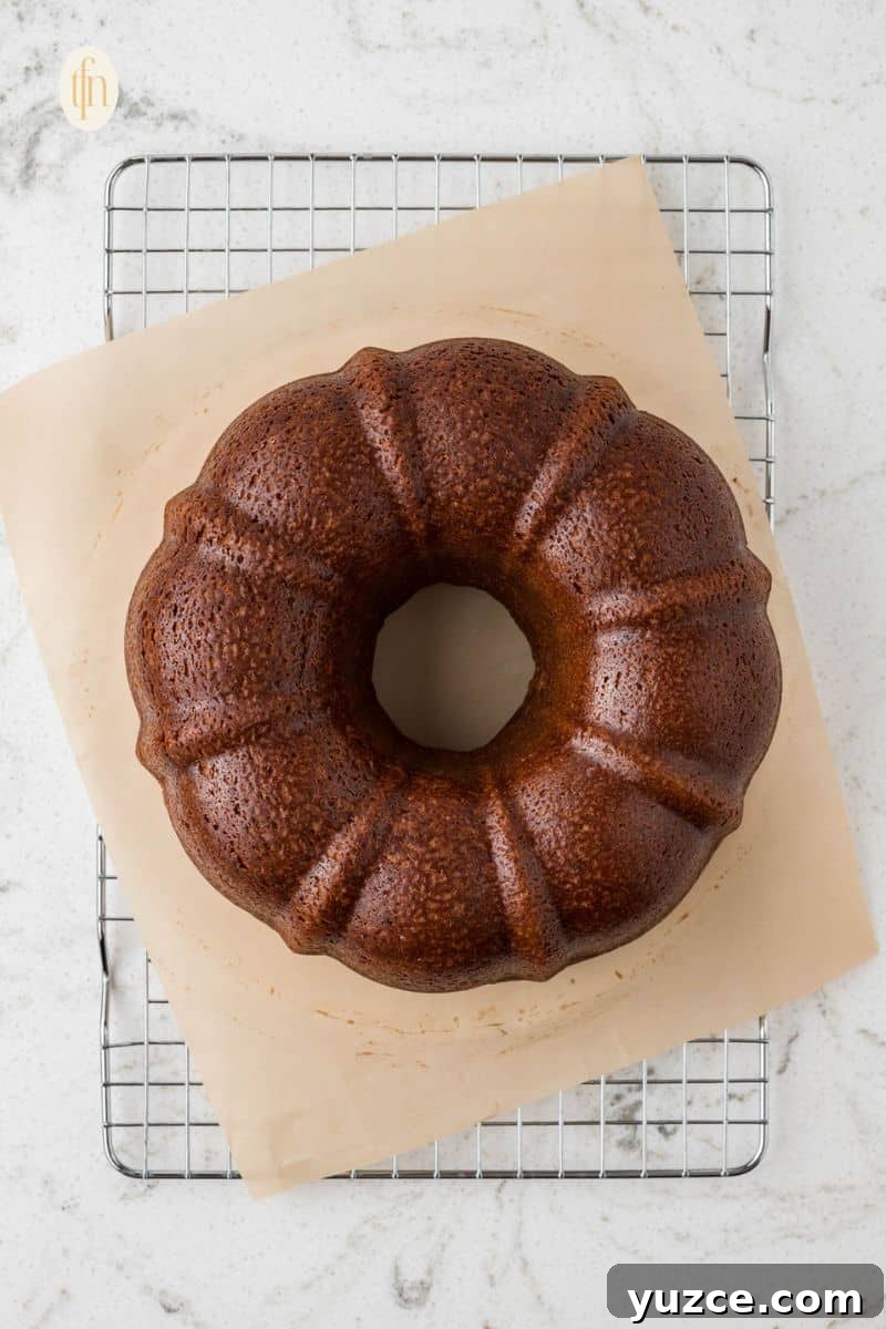 Baked bundt cake on top of a cooling rack.
