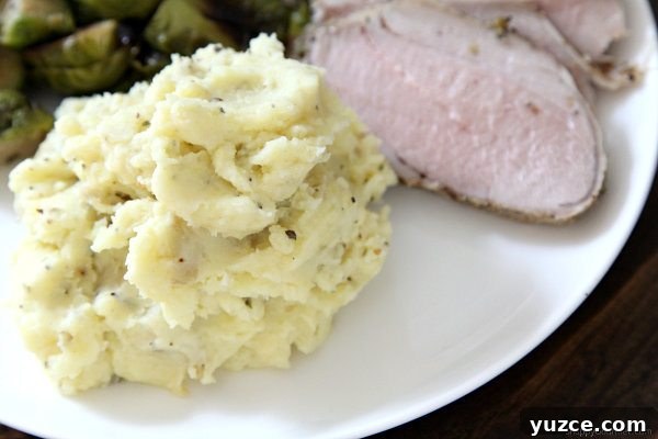 RICOTTA HERB MASHED POTATOES Ricotta Herb Mashed Potatoes on plate with meat and vegetables