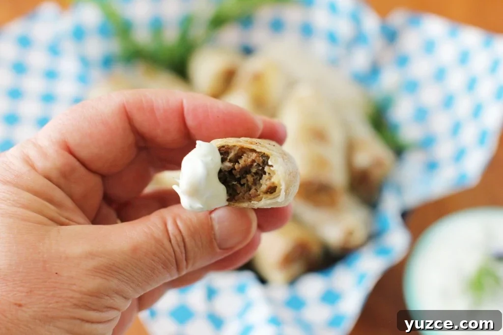 Gluten-Free Beef Sausage Rolls with Creamy Tzatziki Dip 4 mmm, a gluten free sausage roll with a dollop of tzatziki sauce