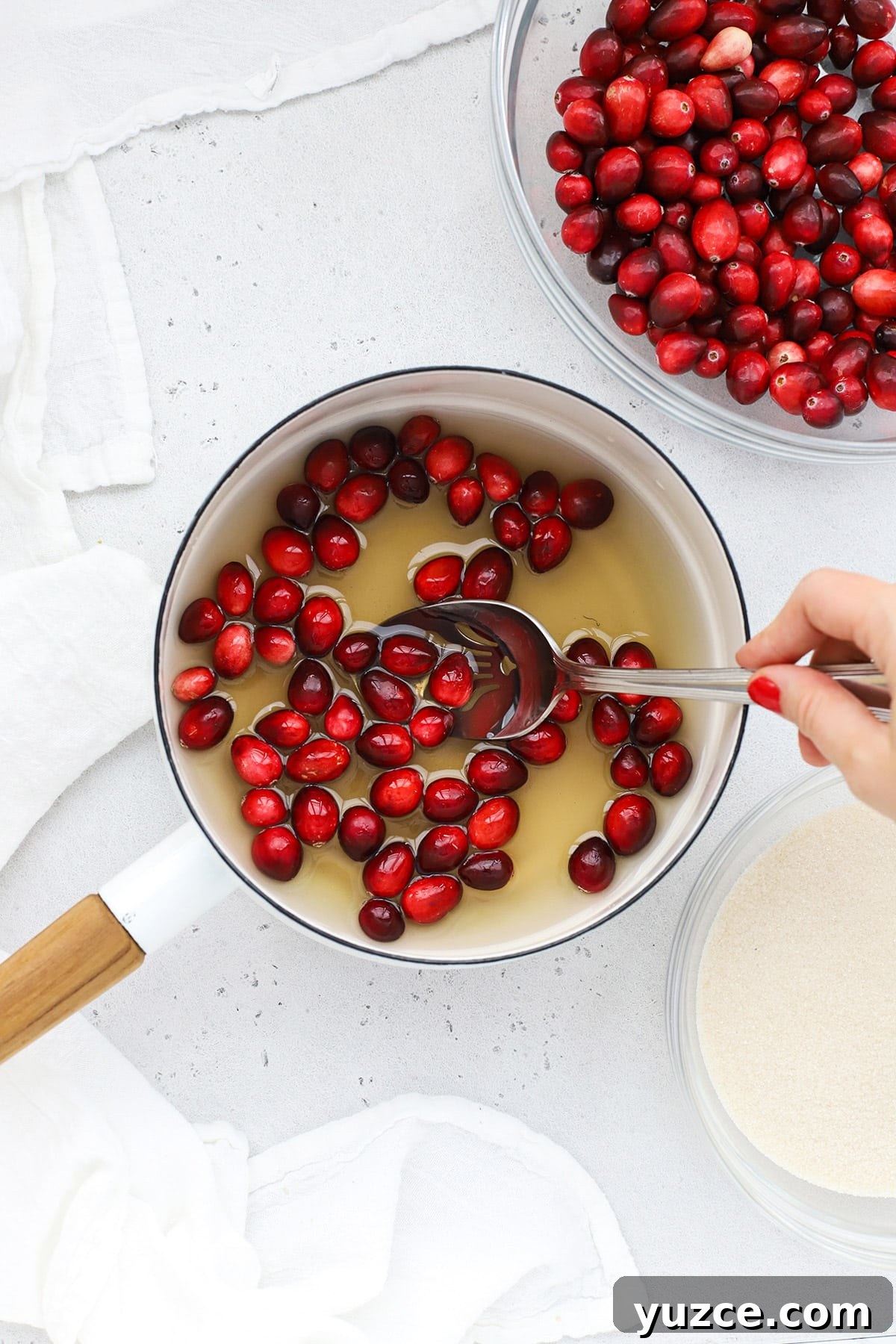 Sugared Cranberries Recipe: Simple Steps for Sparkling Cranberry Garnish 5 Dipping fresh cranberries in simple syrup to make sugared cranberries