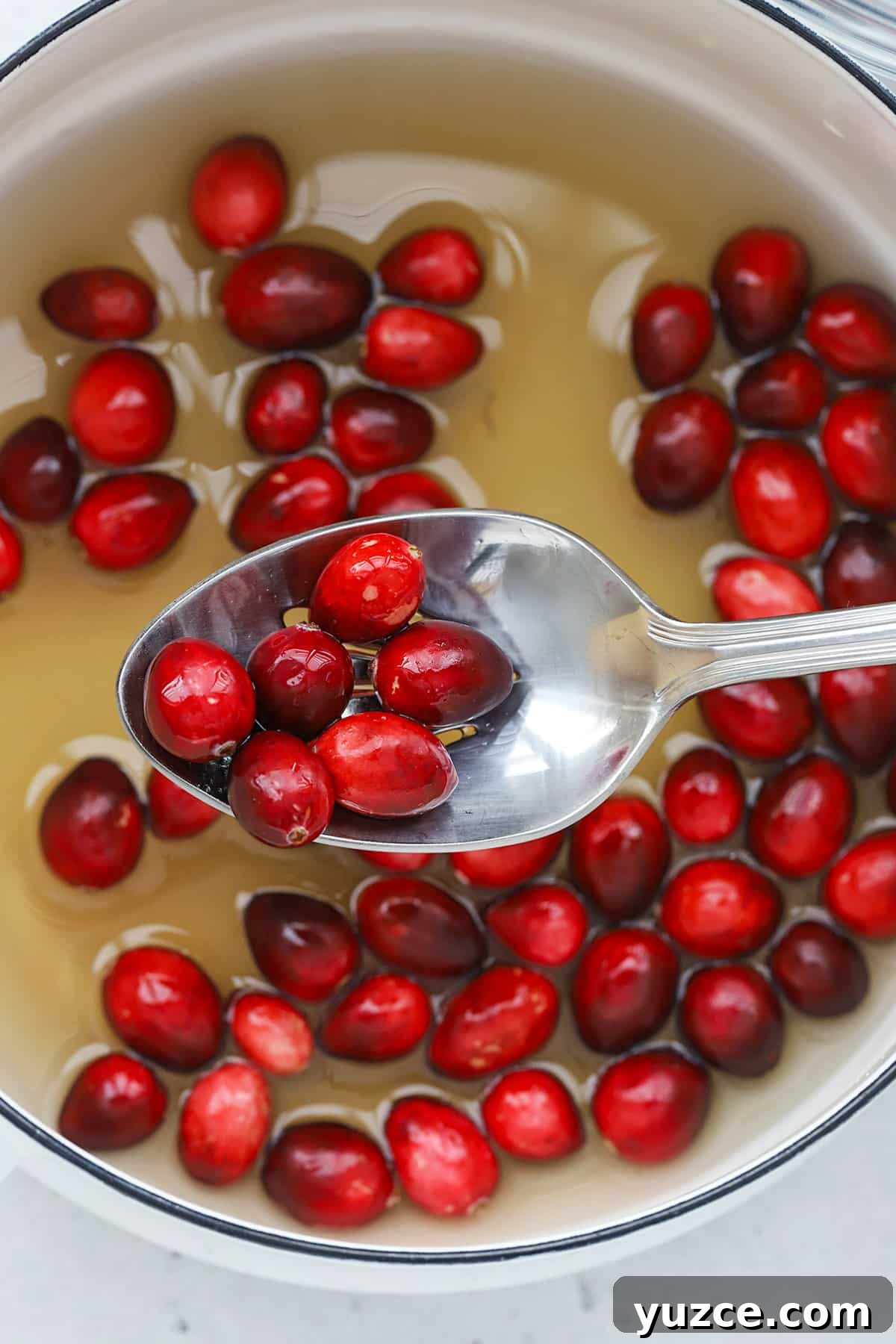 Sugared Cranberries Recipe: Simple Steps for Sparkling Cranberry Garnish 6 Dipping fresh cranberries in simple syrup to make sugared cranberries