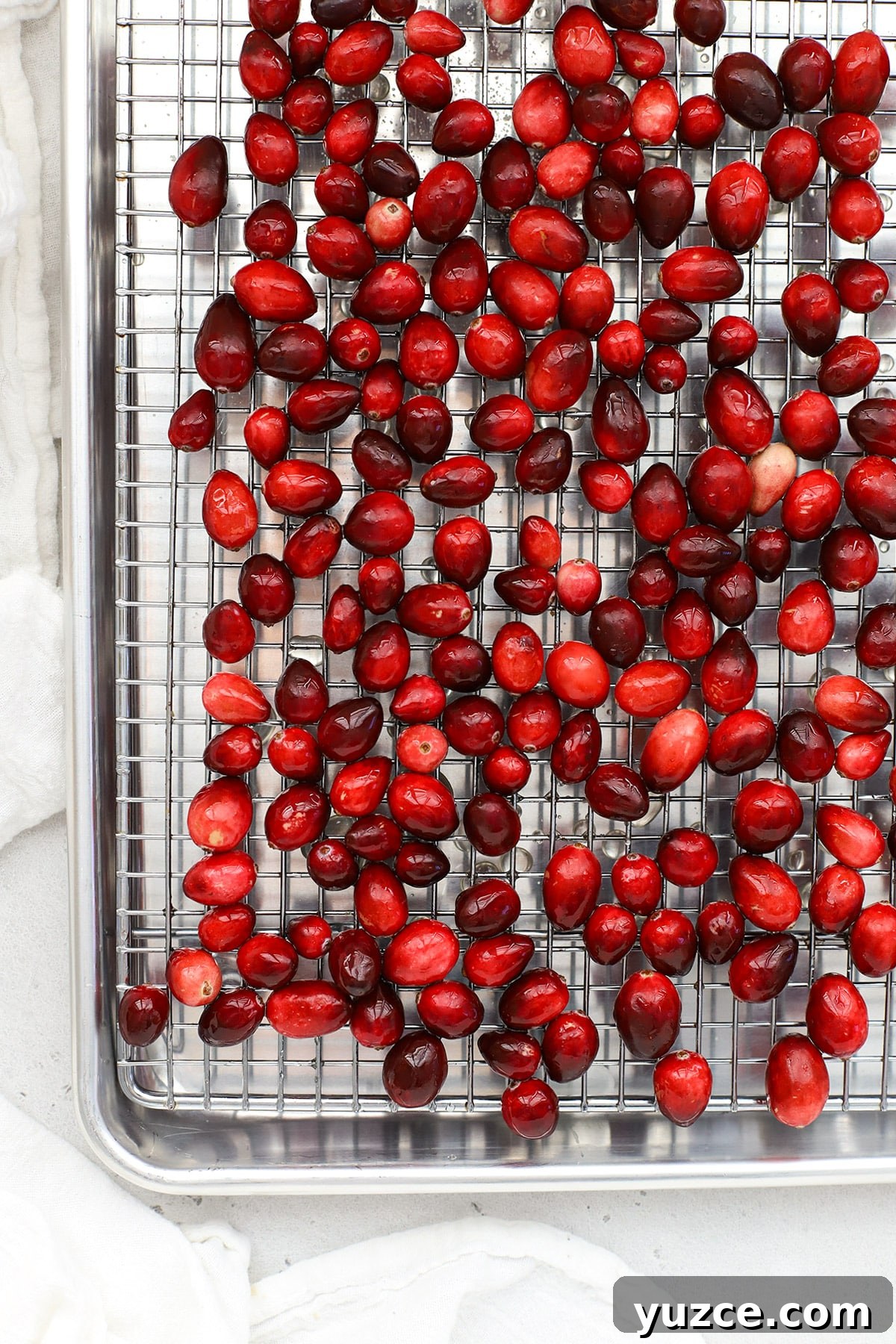 Sugared Cranberries Recipe: Simple Steps for Sparkling Cranberry Garnish 7 Cranberries coated with simple syrup cooling on a drying rack