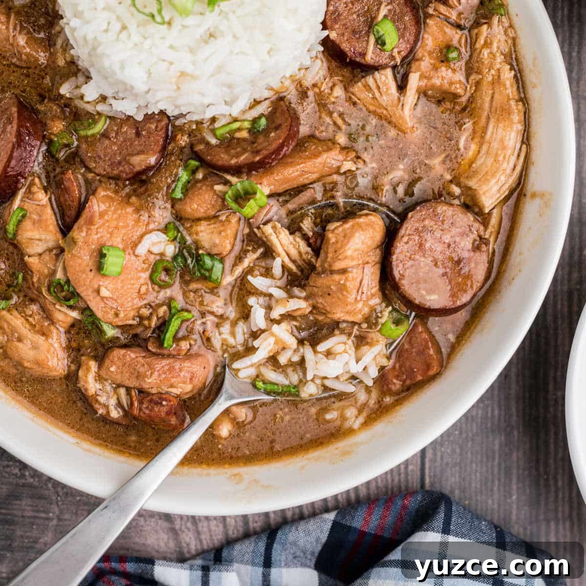 Hearty Dutch Oven Soup Recipes for Cozy Meals 13 a close up of a bowl of chicken and sausage gumbo with a spoon sitting in it