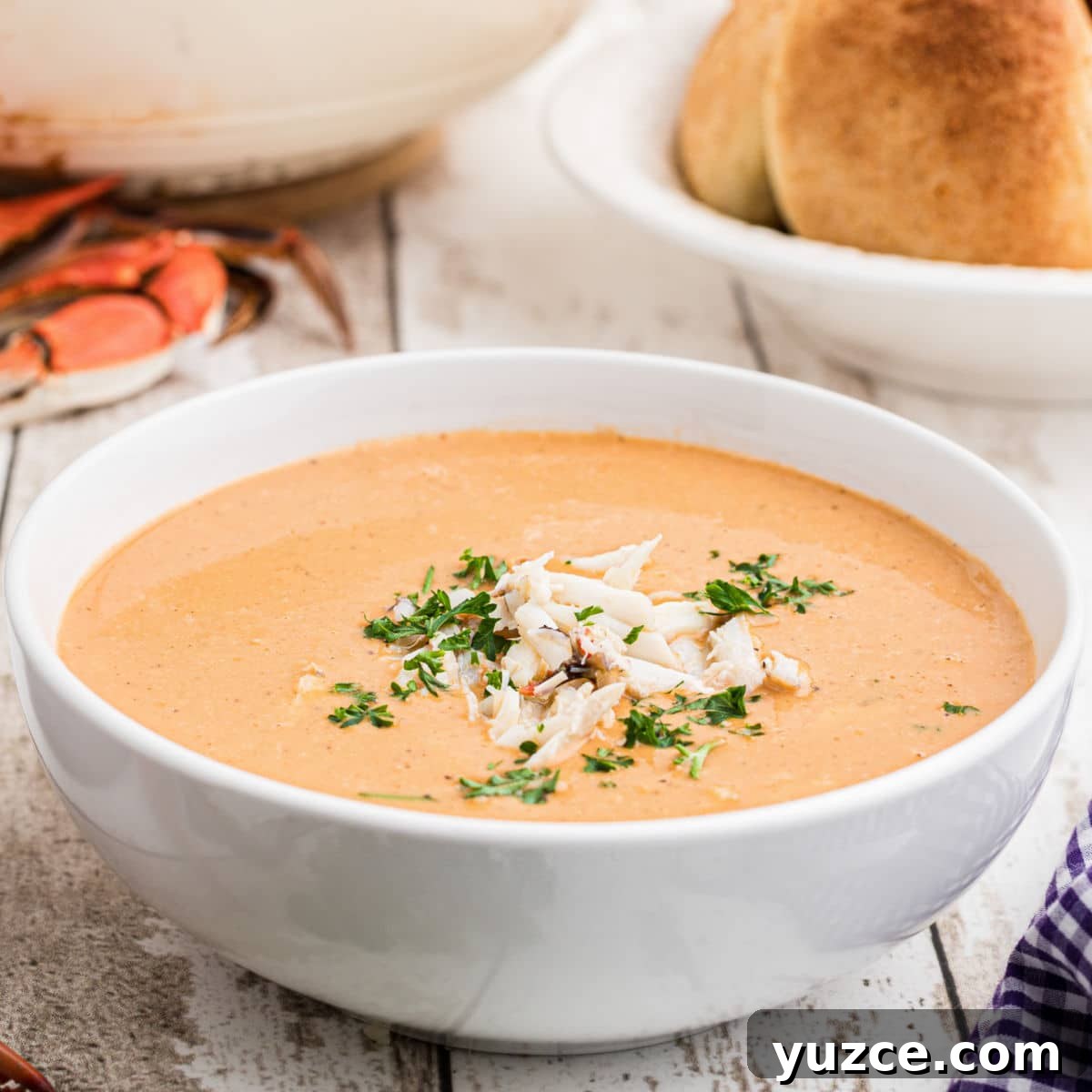 Hearty Dutch Oven Soup Recipes for Cozy Meals 14 side view up close of a bowl of crab soup with a sprinkling of crab meat on top