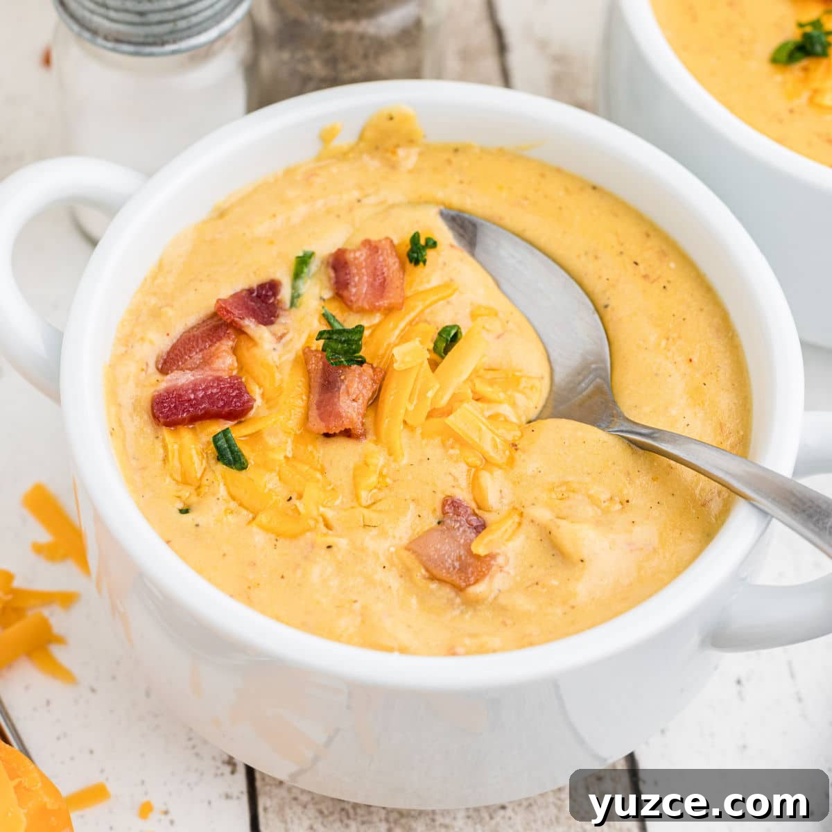 Hearty Dutch Oven Soup Recipes for Cozy Meals 15 picture of a bowl of baked potato soup with bacon and cheese on top