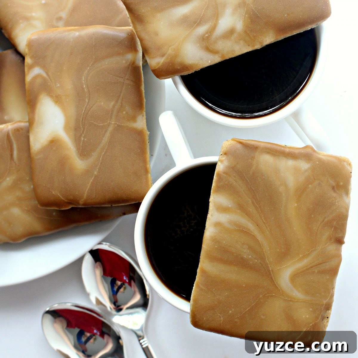 Crispy Coffee Cookies Recipe for Rich, Homemade Flavor 8 Closeup of cookie with swirled icing on top of coffee mug.