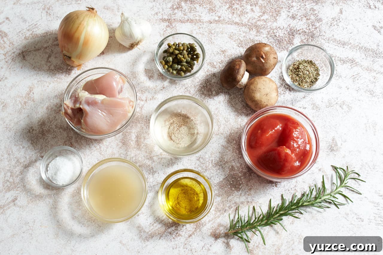 Slow Cooker Chicken Cacciatore Recipe for Tender, Flavorful Meals 3 An onion, a garlic bulb, mushrooms, a sprig of rosemary, and small glass bowls of canned tomatoes, chicken broth, olive oil, capers, spices, and white wine.