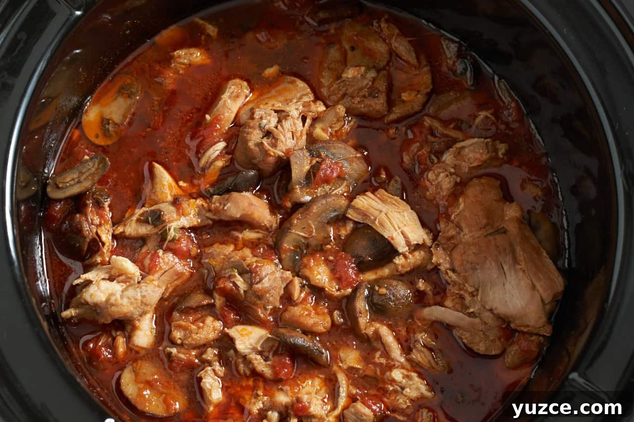 Slow Cooker Chicken Cacciatore Recipe for Tender, Flavorful Meals 9 Finished chicken cacciatore in a black slow cooker.