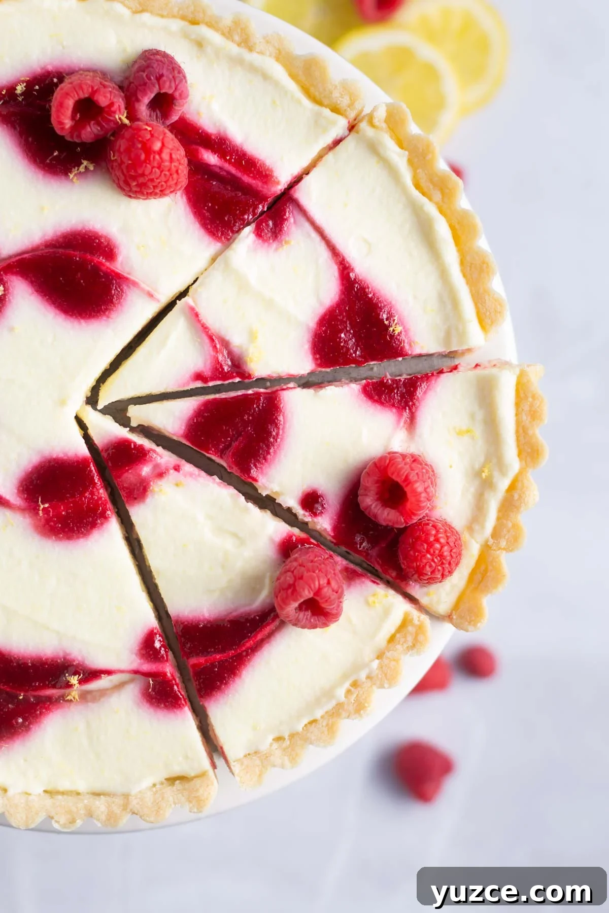 Lemon Raspberry Tart Recipe with a Buttery Shortcrust 2 cut slices of lemon raspberry tart