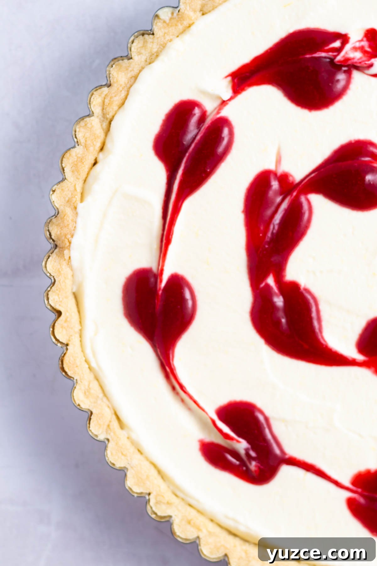 Lemon Raspberry Tart Recipe with a Buttery Shortcrust 14 raspberry coulis "hearts" from a toothpick running through it