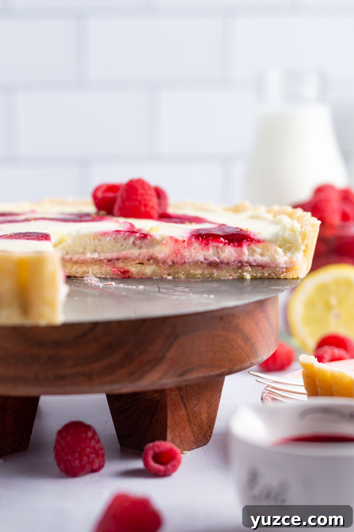Lemon Raspberry Tart Recipe with a Buttery Shortcrust 15 lemon raspberry tart sitting on a cake stand